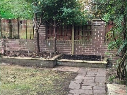 The original cracked brick retaining wall and tired paving before the rebuild